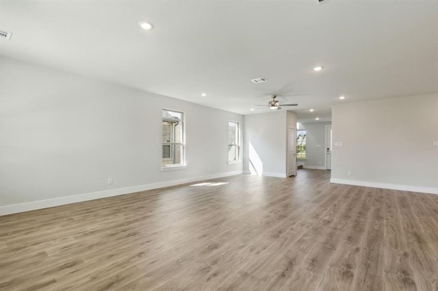 Unfurnished living room featuring light hardwood / wood-style flooring and ceiling fan