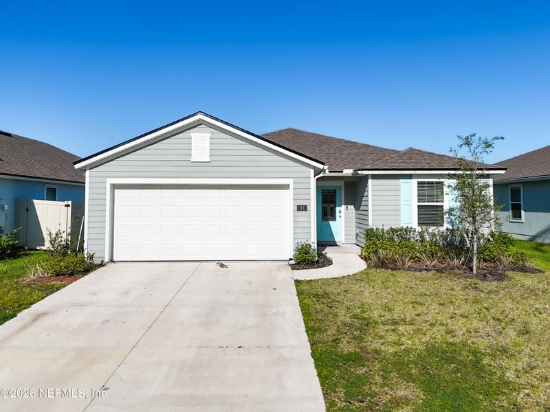 Front exterior of a new home in Dorado at Entrada, St. Augustine, FL, highlighting curb appeal (Image 26).