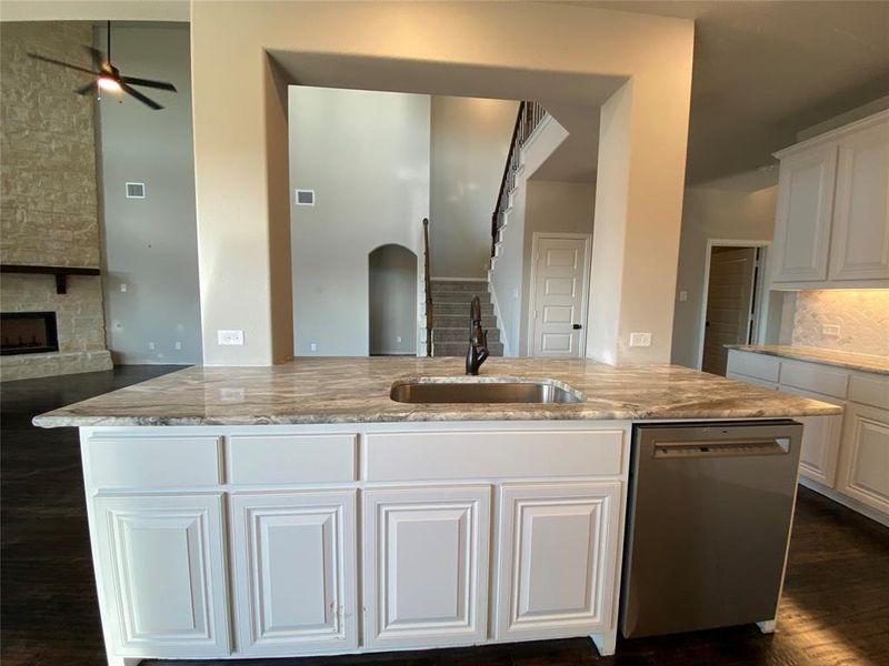 Hige kitchen island for entertaining has a stainless undermount sink with ORB extendable faucet