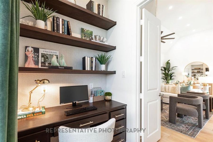 Office space with light wood finished floors, built in features, built in desk, ceiling fan, and recessed lighting