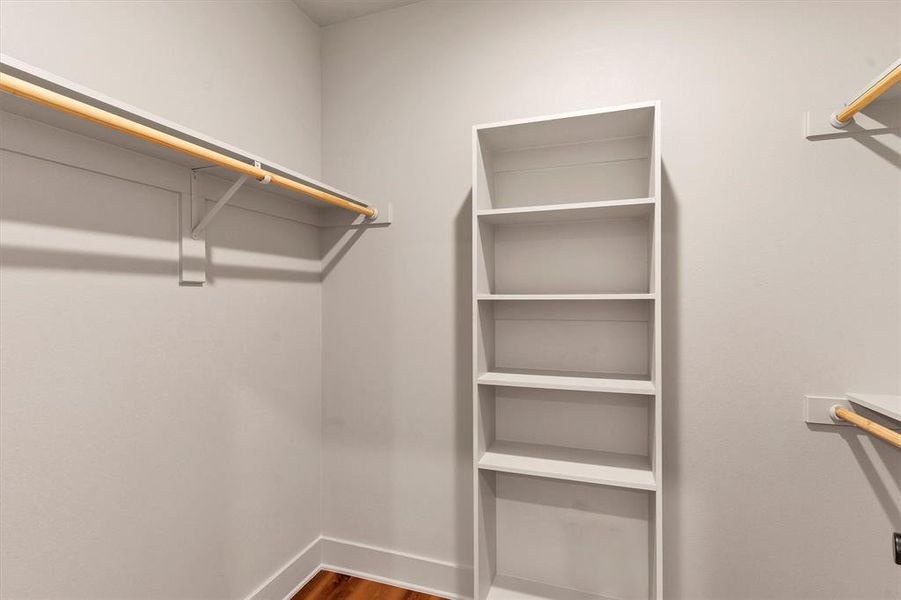 Spacious closet with dark wood-style floors Spacious closet with dark wood-style floors