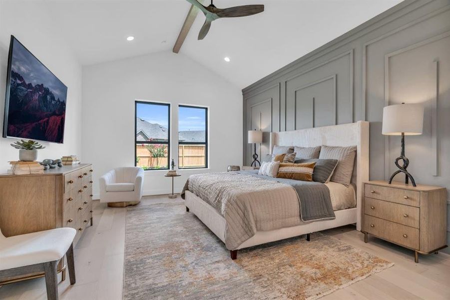 Primary bedroom with a ceiling beam and accent wall.