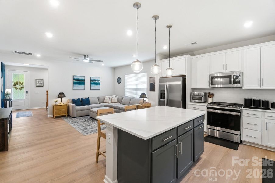 Stylish accent-colored island in the much loved white kitchen!