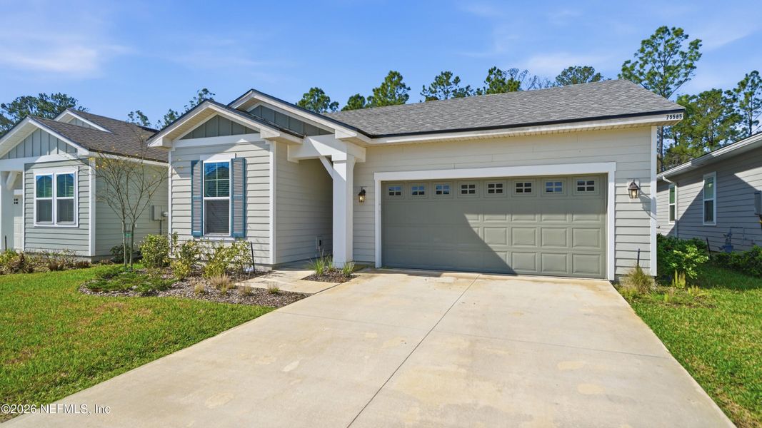 Front exterior of a new home in Tributary, Yulee, FL, highlighting curb appeal (Image 24).