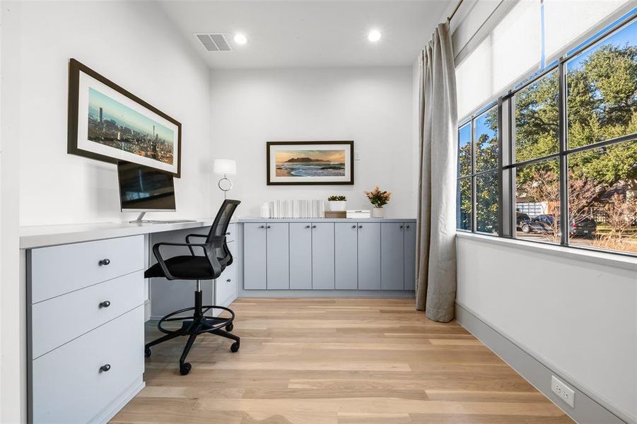 Home office with light wood-style floors, recessed lighting, and built in study area