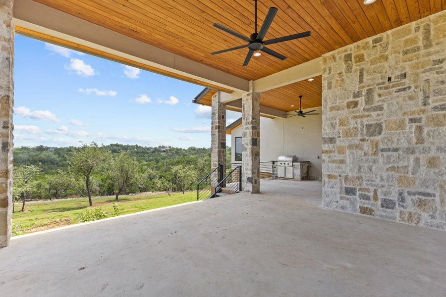 An inviting covered patio offers outdoor entertaining with a built-in grill and serene hillside views. An inviting covered patio offers outdoor entertaining with a built-in grill and serene hillside views.