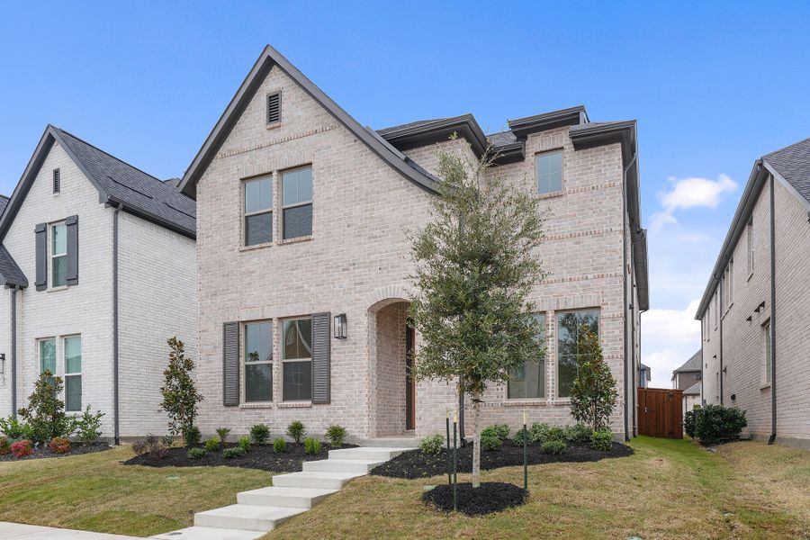 Front exterior of a new home in Light Farms Brenham - 40' Lots, Celina, TX, highlighting curb appeal (Image 23). Front exterior of a new home in Light Farms Brenham - 40' Lots, Celina, TX, highlighting curb appeal (Image 23).