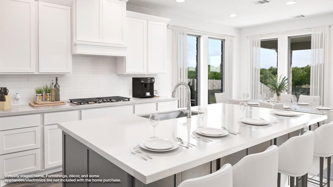 Kitchen featuring white cabinets, an island with sink, light countertops, a kitchen breakfast bar, and recessed lighting Kitchen featuring white cabinets, an island with sink, light countertops, a kitchen breakfast bar, and recessed lighting