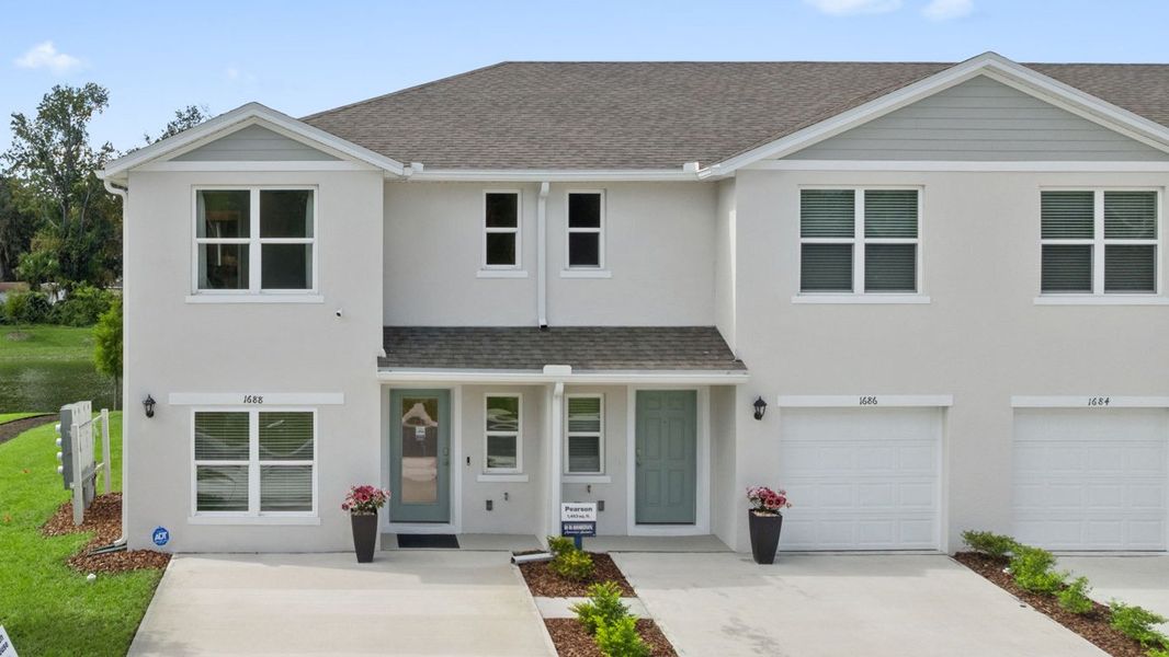 Front exterior of a new home in The Vineyards Townhomes, Holly Hill, FL, highlighting curb appeal (Image 1). Front exterior of a new home in The Vineyards Townhomes, Holly Hill, FL, highlighting curb appeal (Image 1).