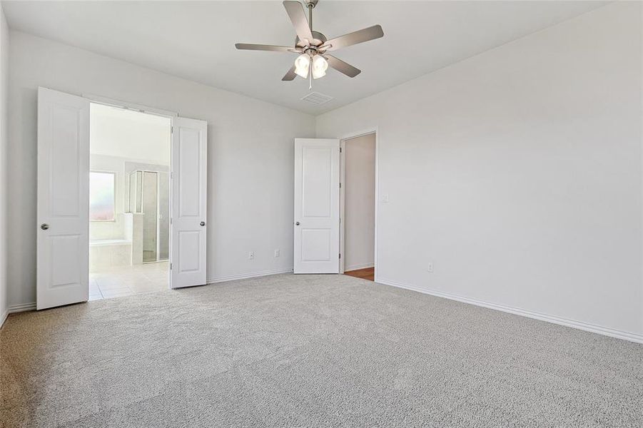 Empty room with light carpet and ceiling fan