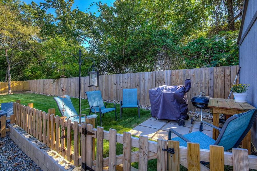 Fenced backyard with a patio area
