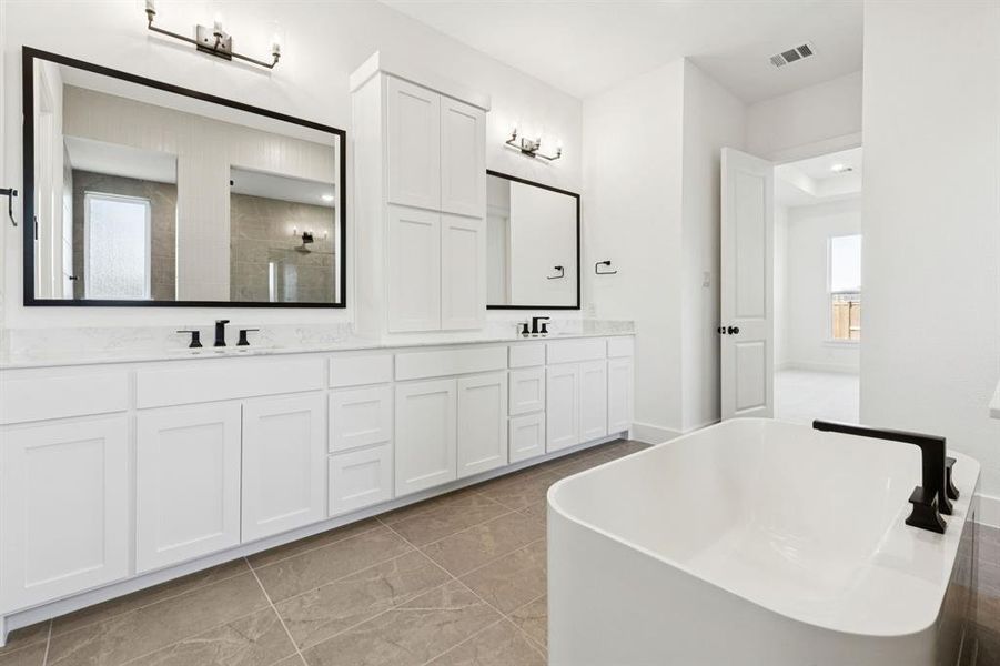 With his and her vanities, there is plenty of room for 2 in this lovely owner's bath.