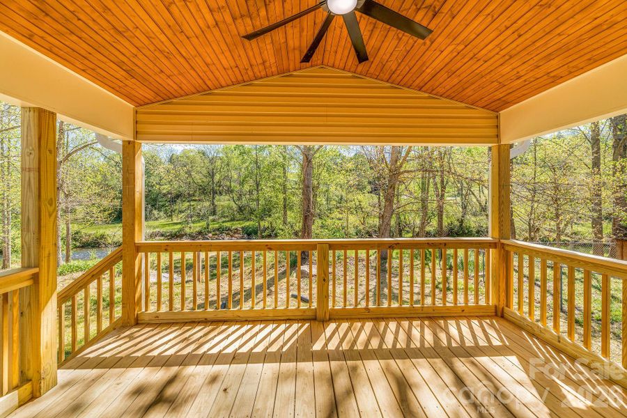 covered private back deck with view of creek