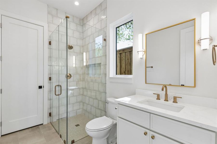 Full bath featuring a stall shower and vanity