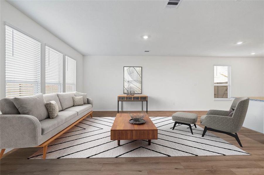 Gather the family and guests together in your lovely family room! Featuring high ceilings, recessed lighting, custom paint, gorgeous vinyl plank flooring, and a wall of windows that provide plenty of natural lighting throughout the day!