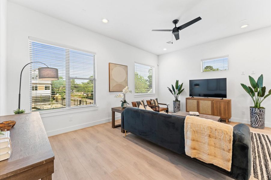 Sleek modern kitchen featuring stainless steel appliances, a spacious island with bar seating, and elegant pendant lighting.