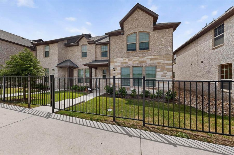 The property features an attractive brick and stone exterior with prominent arched windows