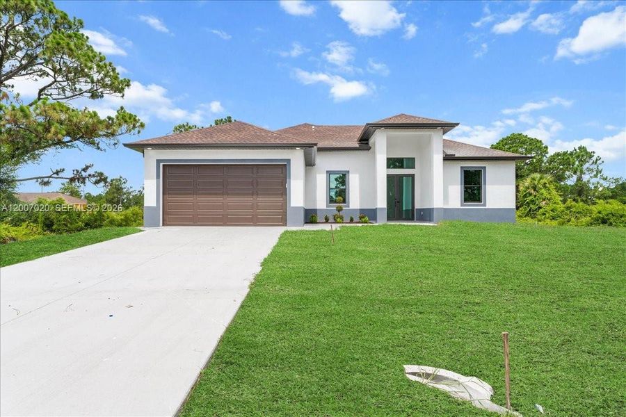 Front exterior of a new home in , Lehigh Acres, FL, highlighting curb appeal (Image 27).