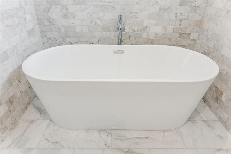 Separate Soaking Tub that is Surrounded by Marble. Separate Soaking Tub that is Surrounded by Marble.