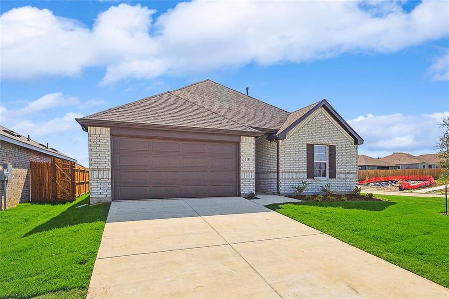 Ranch-style home featuring a garage and a front yard