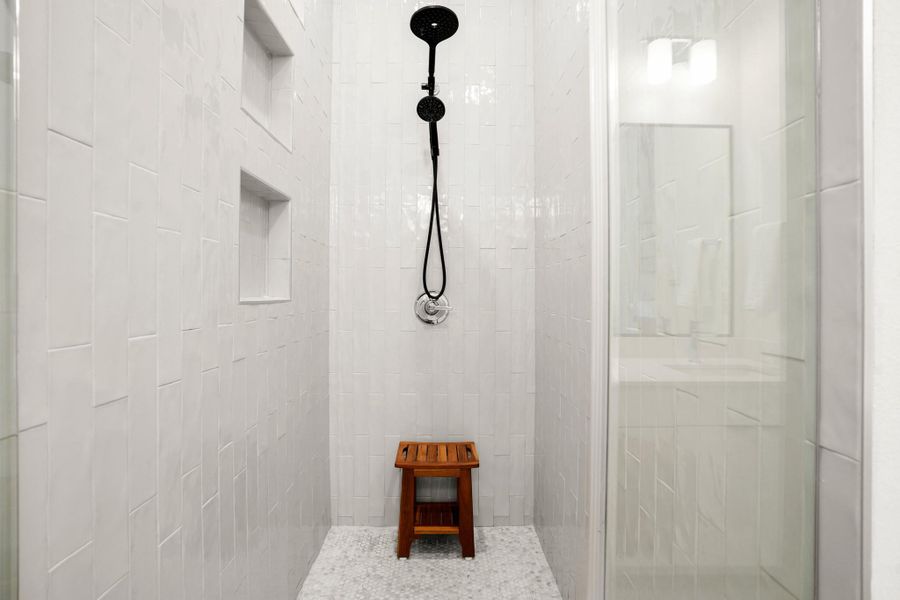 Enjoy a large frameless glass walk-in shower with gorgeous tile surround. Enjoy a large frameless glass walk-in shower with gorgeous tile surround.