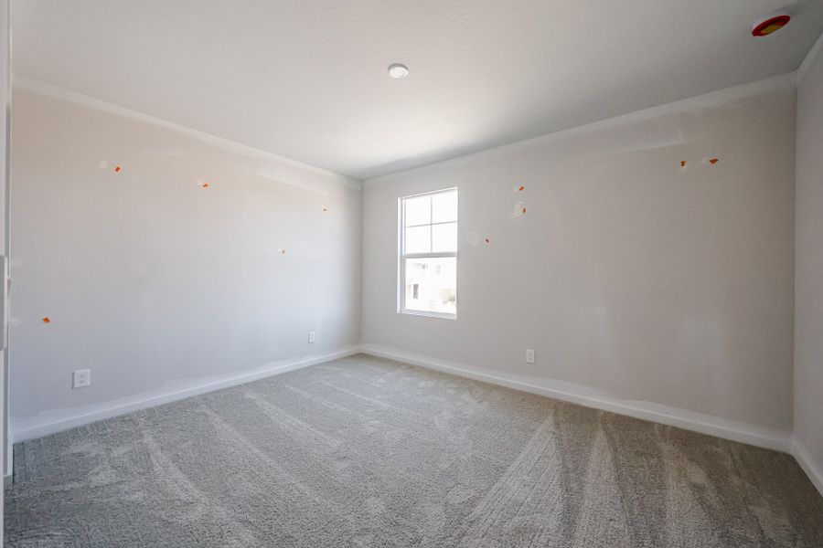A room with a window and a carpet. A room with a window and a carpet.
