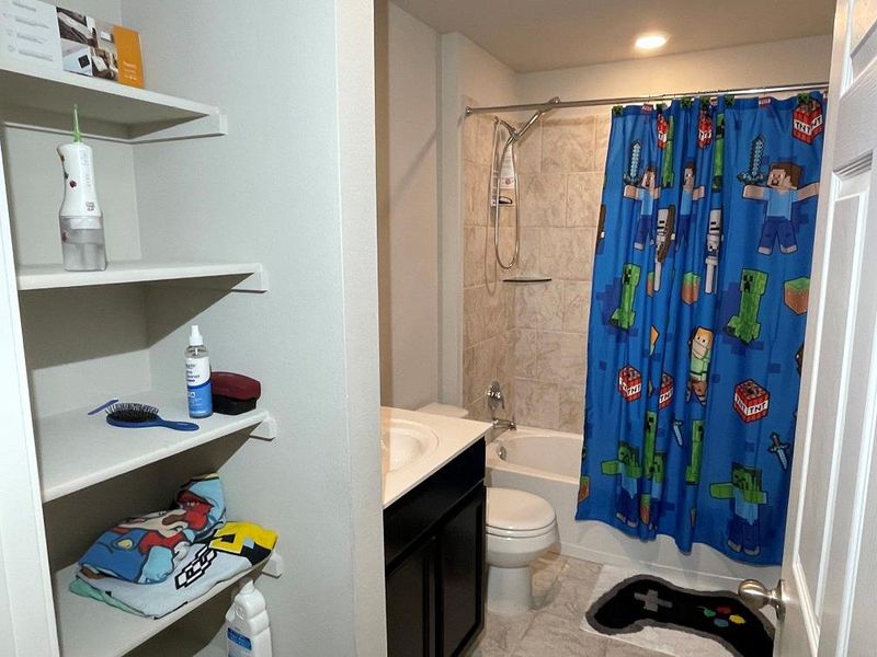 Full bathroom with shower / bath combo with shower curtain and vanity