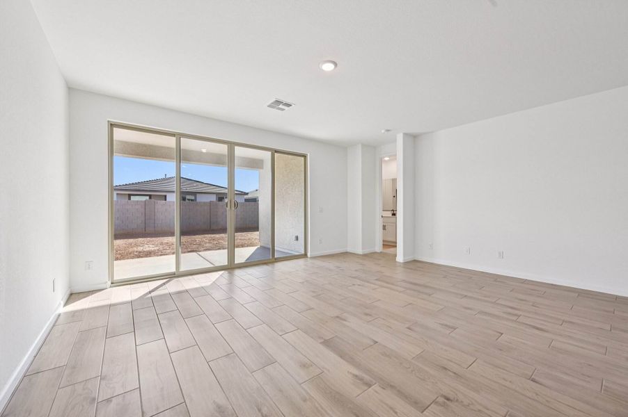 Great room with upgraded 4 panel slider. Finishes and options may vary by community.