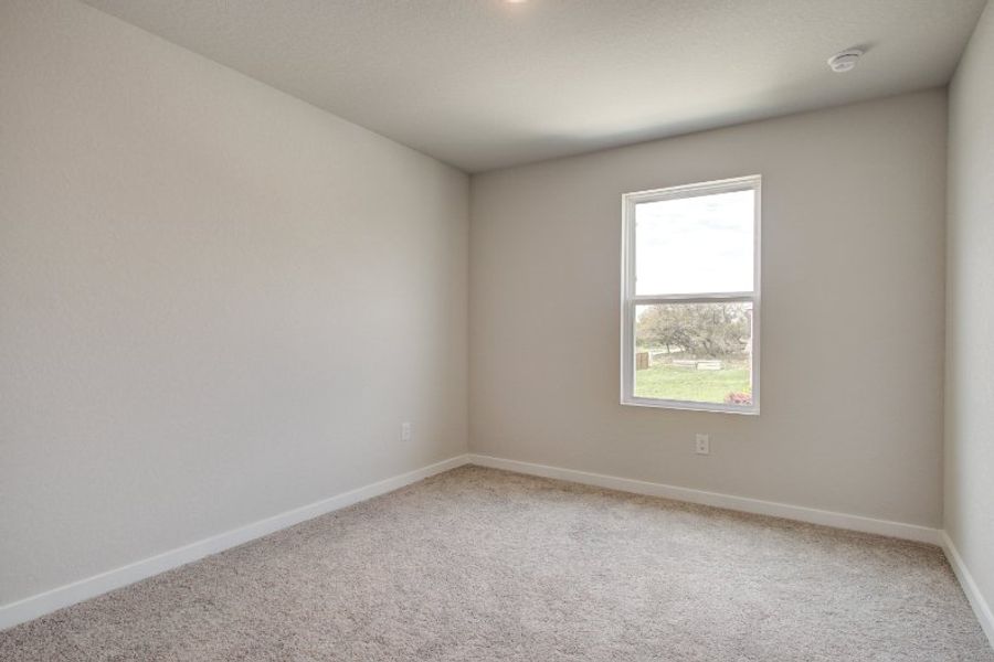 A room with a window and a carpet. A room with a window and a carpet.
