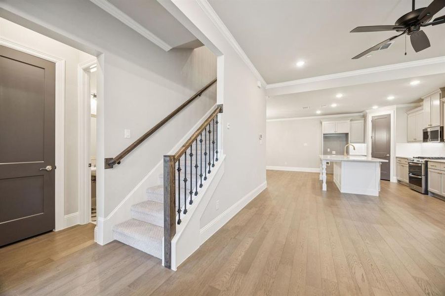 View of stairs and large open floor plan from front door.