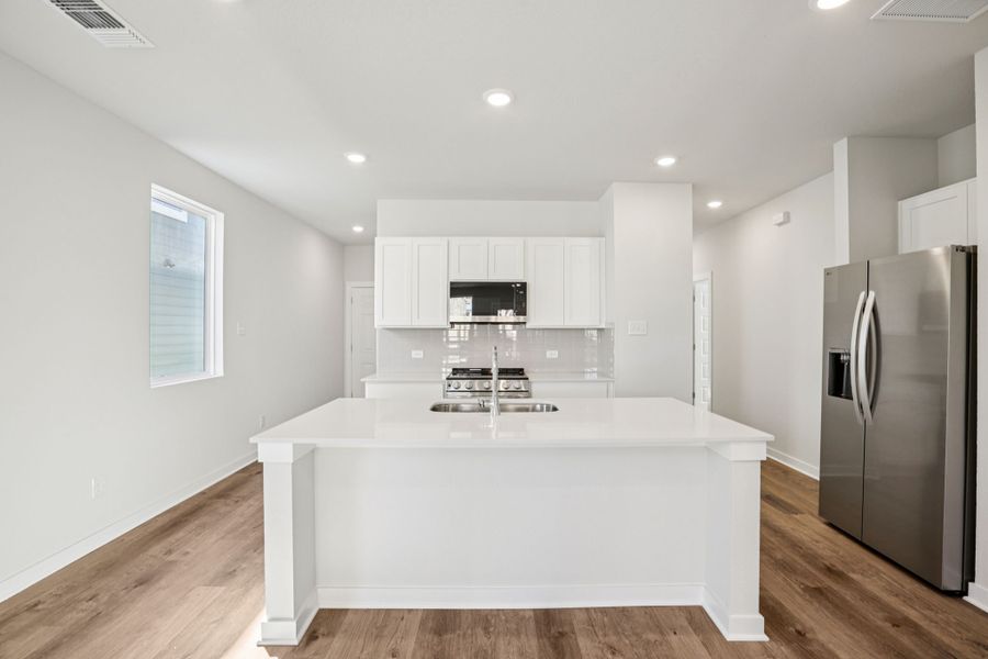 A kitchen with white cabinets. A kitchen with white cabinets.