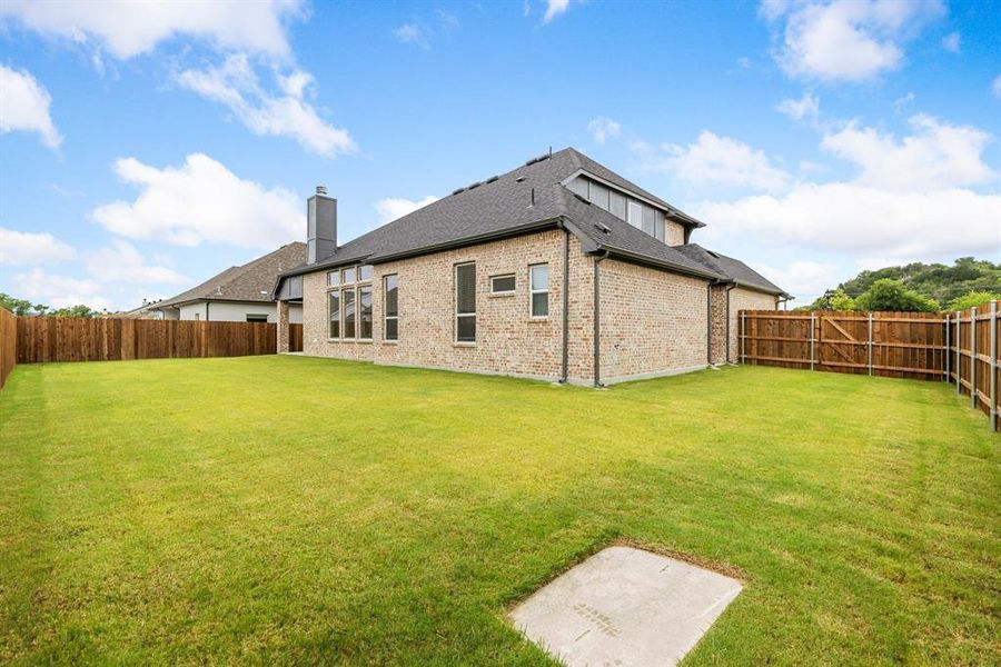 Rear view of house featuring a yard