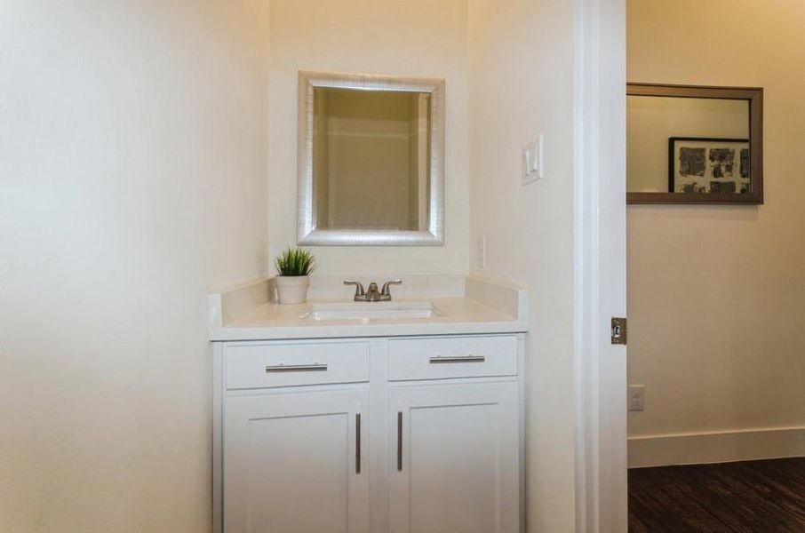 Bathroom featuring vanity and wood-type flooring