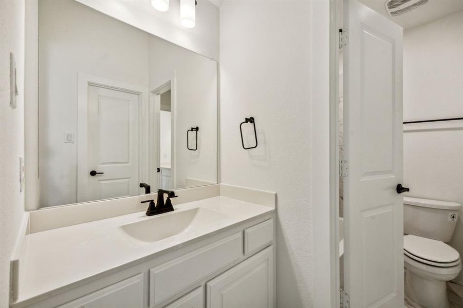 Bathroom featuring vanity and toilet