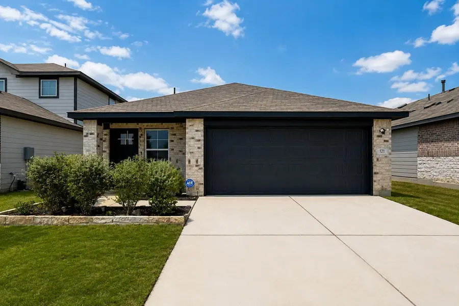 A welcoming facade showcases brick accents, a dark garage door, and neat landscaping. A welcoming facade showcases brick accents, a dark garage door, and neat landscaping.