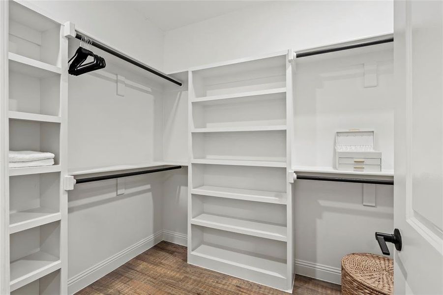 Walk in closet featuring dark wood-style flooring