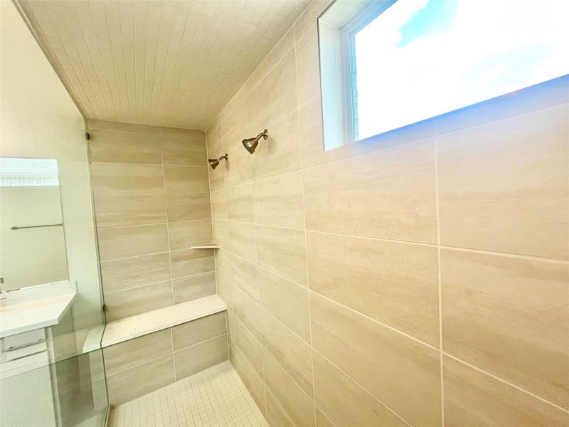 Full bathroom with a tile shower and vanity Full bathroom with a tile shower and vanity