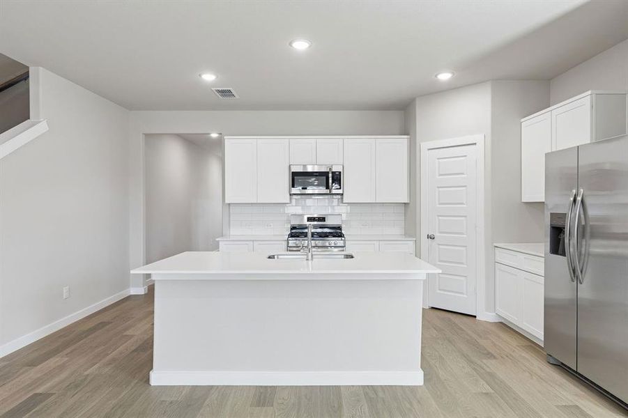 Kitchen in the Holden home plan by Trophy Signature Homes – REPRESENTATIVE PHOTO