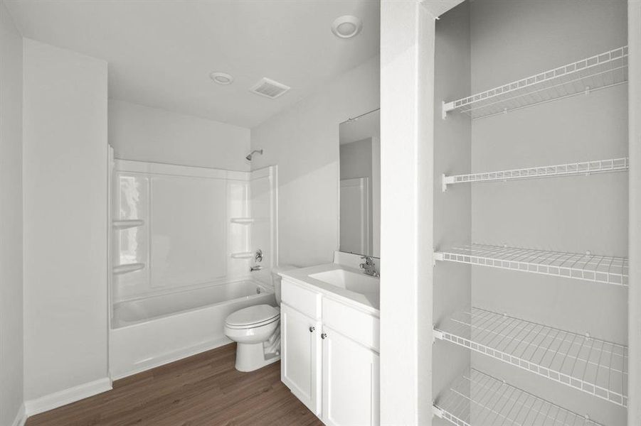 The secondary bathroom has plenty of storage.