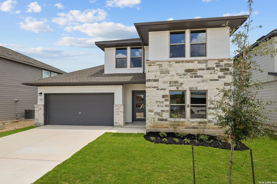 Front exterior of a new home in Summerlin, San Antonio, TX, highlighting curb appeal (Image 2). Front exterior of a new home in Summerlin, San Antonio, TX, highlighting curb appeal (Image 2).