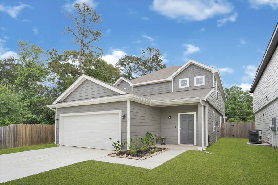 Front exterior of a new home in River's Edge, Conroe, TX, highlighting curb appeal (Image 23).