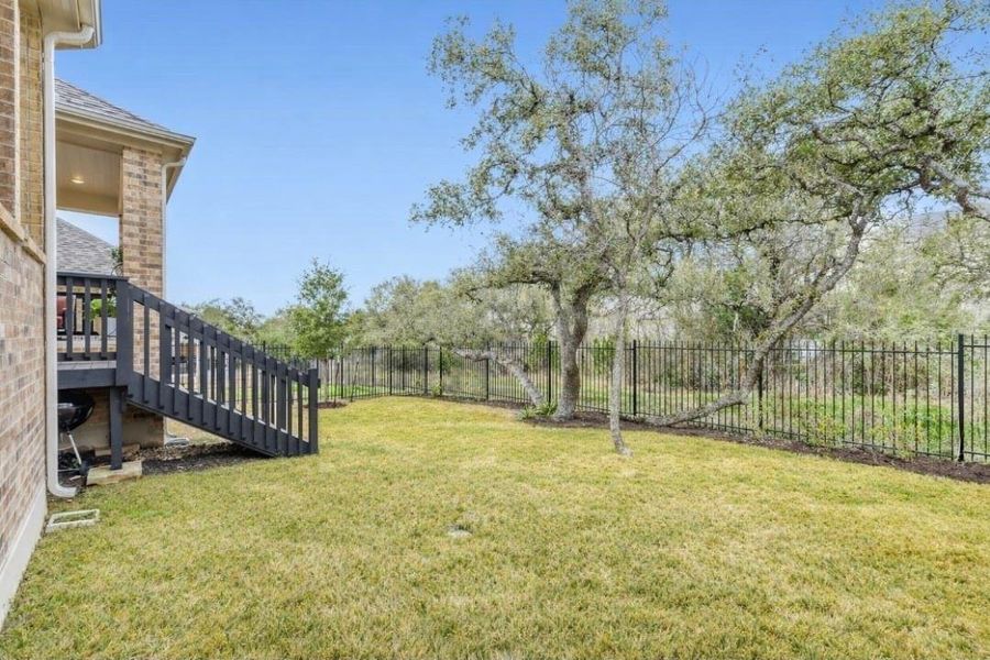 Fenced backyard featuring stairs