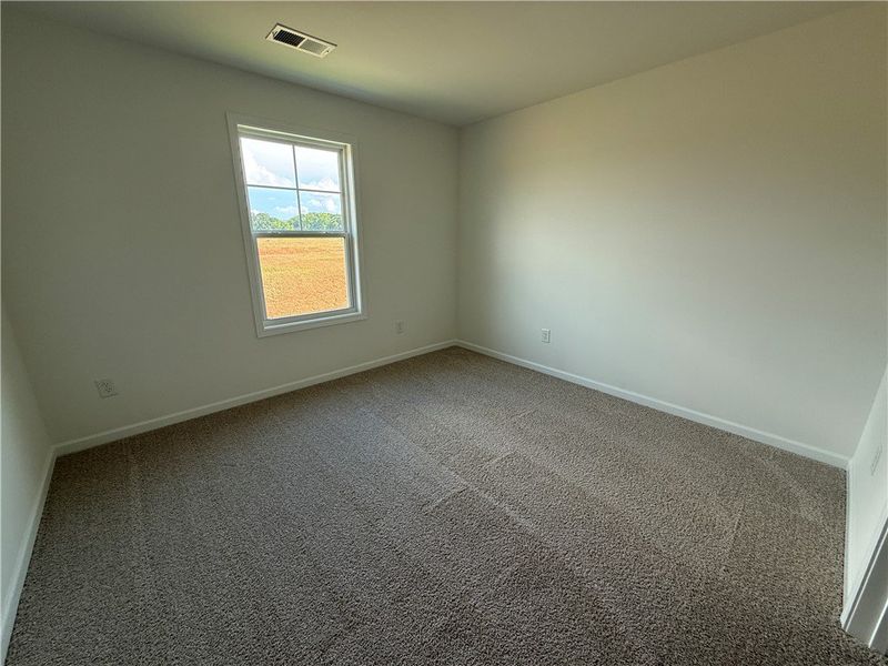 A well-lit, neutral-toned room features clean carp A well-lit, neutral-toned room features clean carp