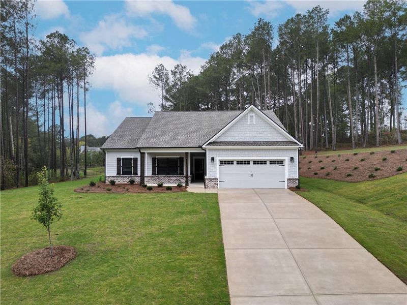 Front exterior of a new home in Red Oak Ridge, Loganville, GA, highlighting curb appeal (Image 1). Front exterior of a new home in Red Oak Ridge, Loganville, GA, highlighting curb appeal (Image 1).