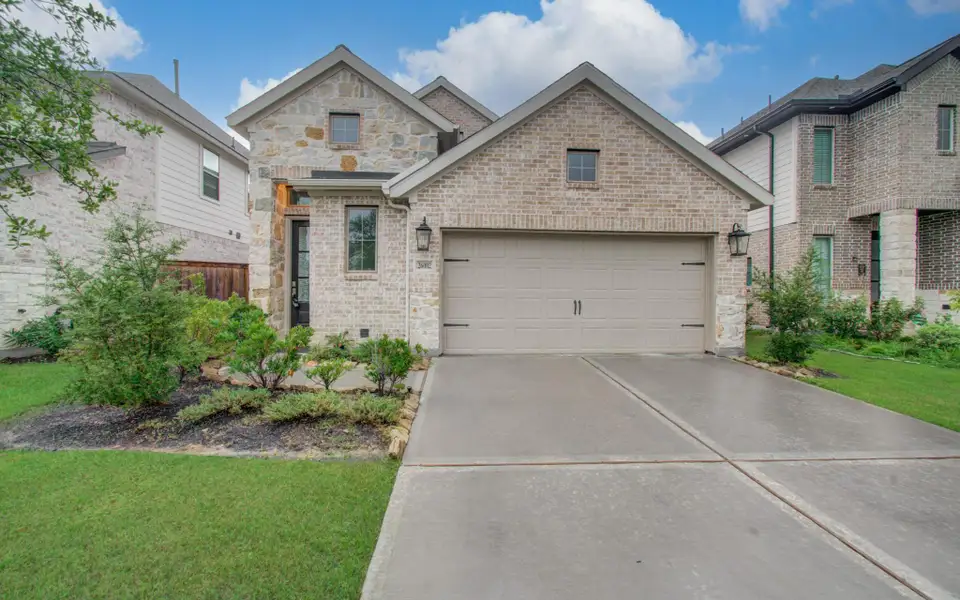 Front exterior of a new home in Candela, Richmond, TX, highlighting curb appeal (Image 2). Front exterior of a new home in Candela, Richmond, TX, highlighting curb appeal (Image 2).