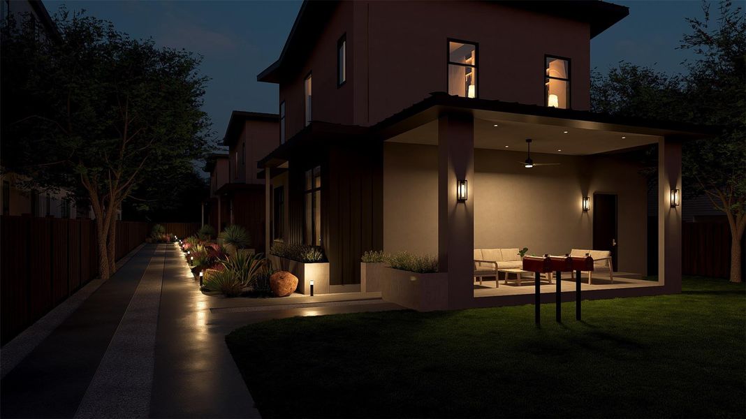 Back of house at twilight with an outdoor lounge area, stucco siding, and a patio area