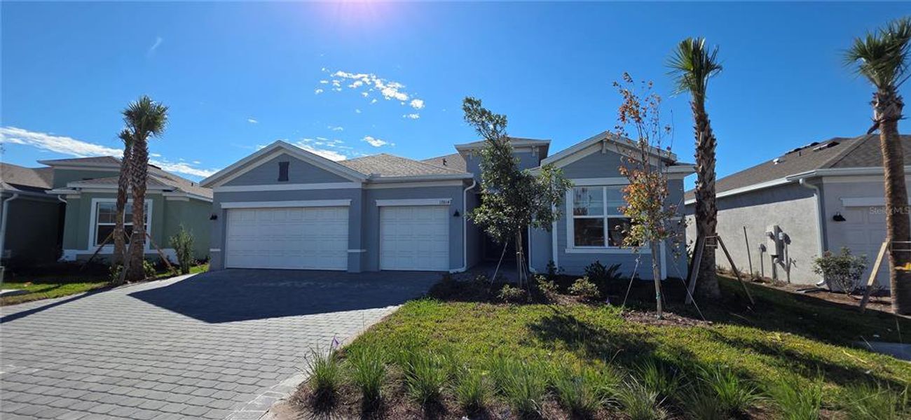 Front exterior of a new home in Rye Ranch: Manor Homes, Parrish, FL, highlighting curb appeal (Image 13).