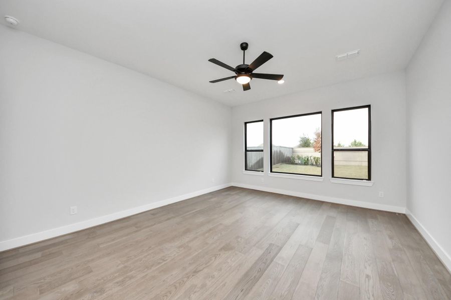 Beautiful wood floors extend into the primary bedroom