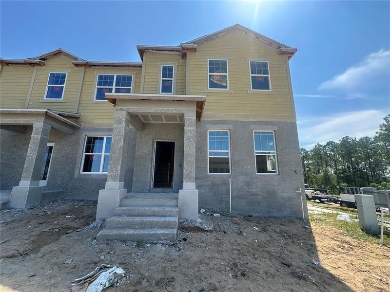 Front exterior of a new home in Tribute at Ovation, Winter Garden, FL, highlighting curb appeal (Image 2).