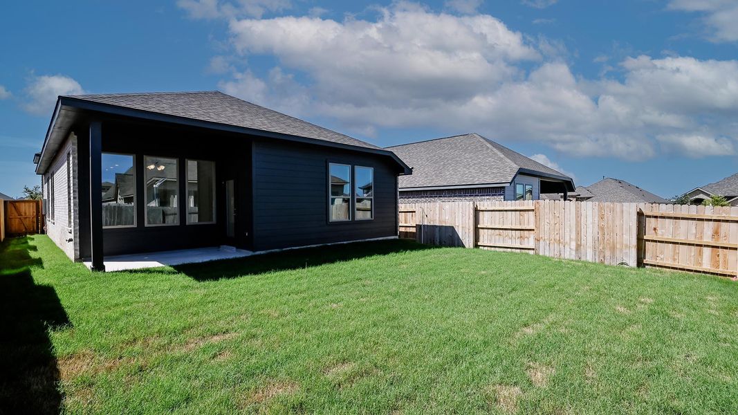 Rear view of house featuring roof with shingles, a fenced backyard, and a patio area Rear view of house featuring roof with shingles, a fenced backyard, and a patio area